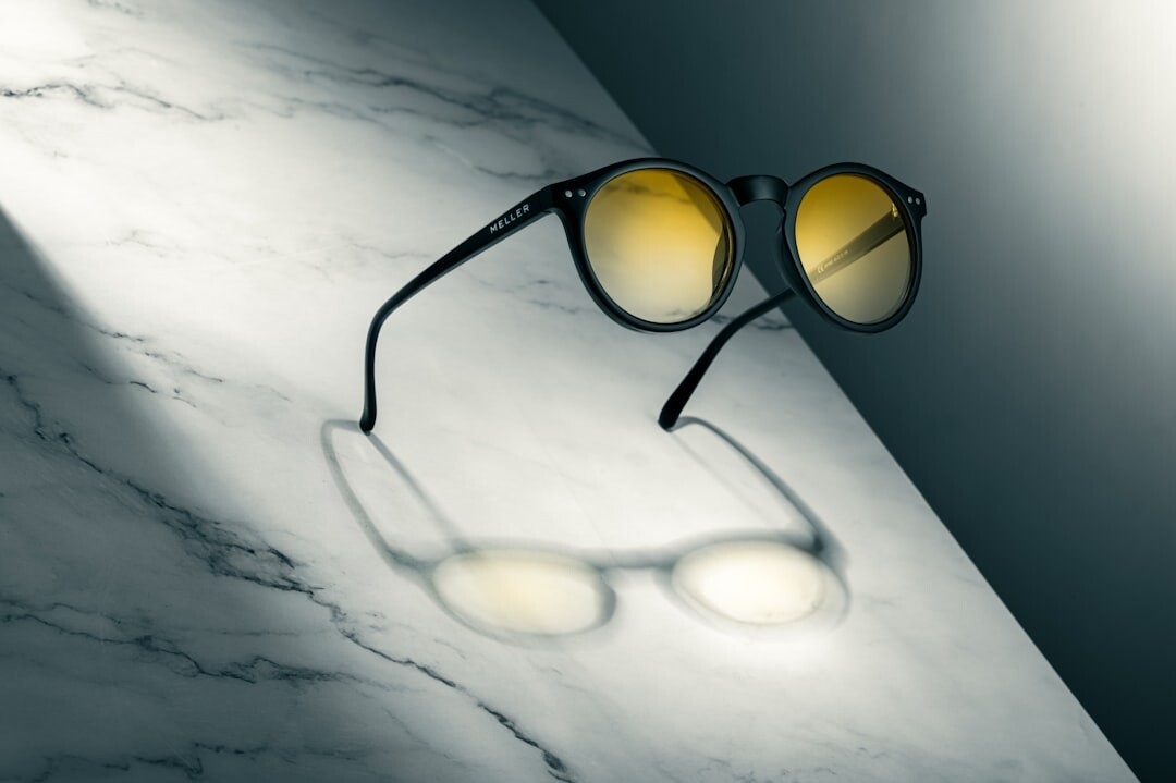 Designer sunglasses resting on a polished marble surface