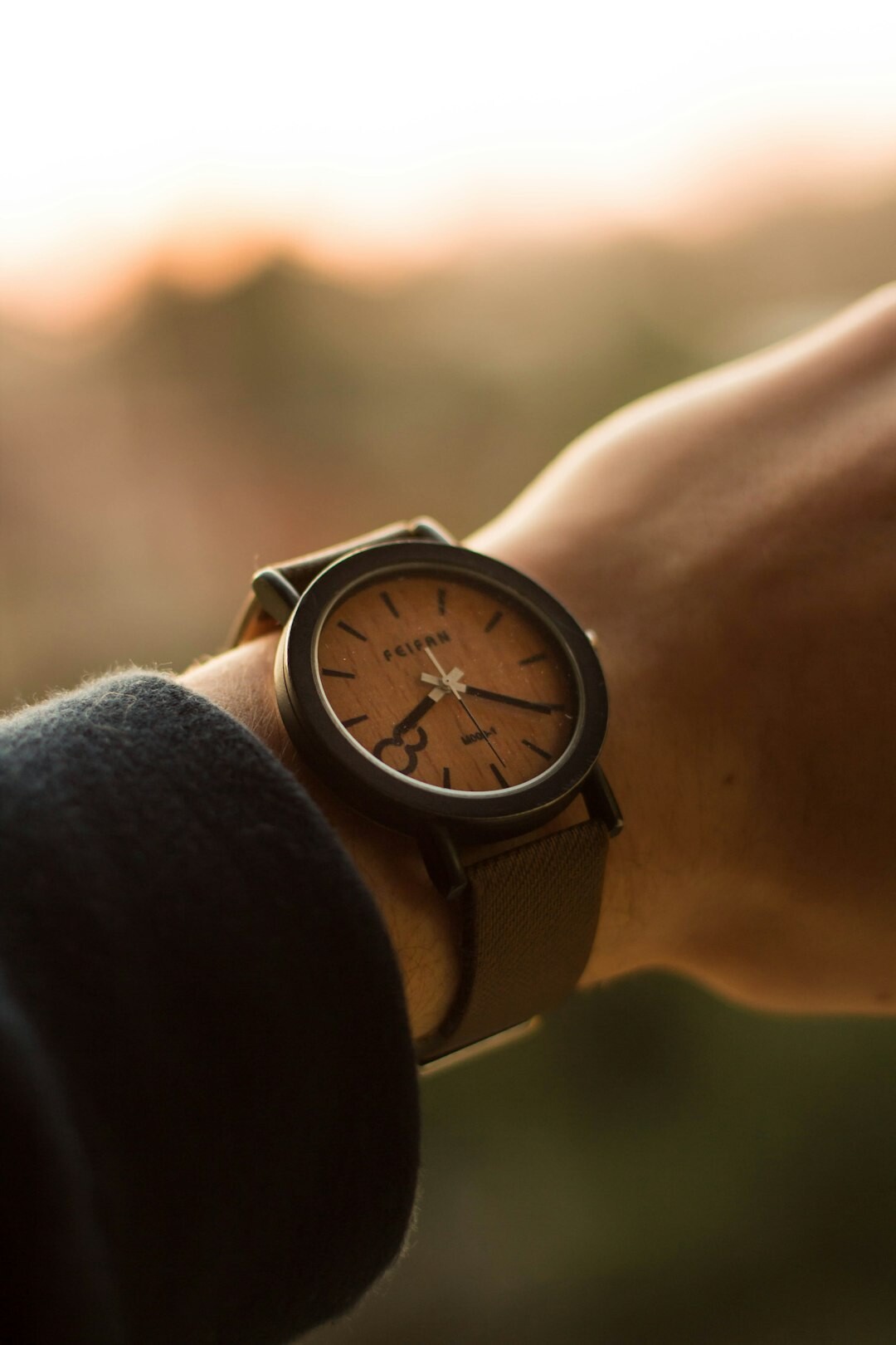 Minimalist leather strap wristwatch on a man's wrist