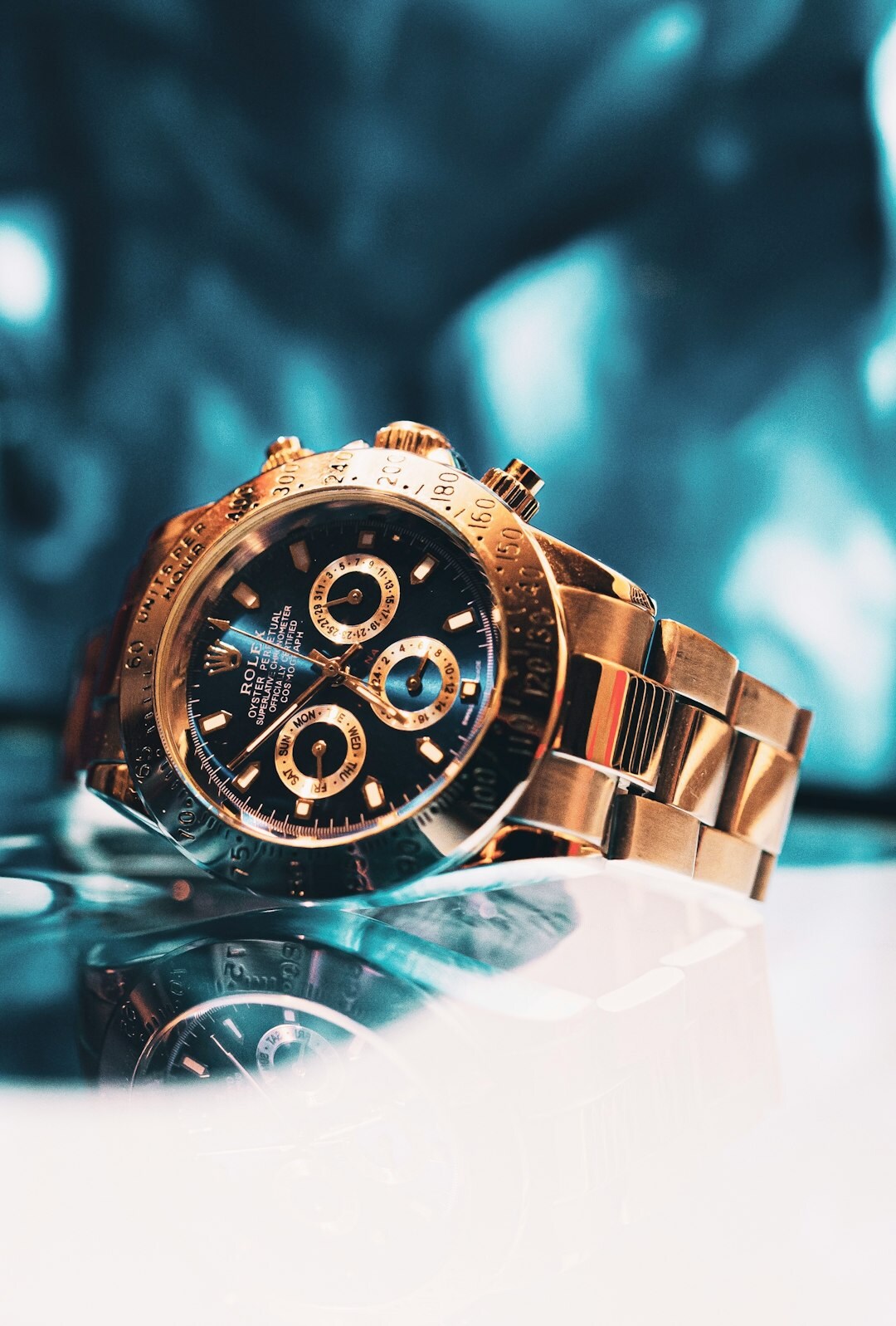Luxury gold chronograph watch displayed on dark velvet cushion