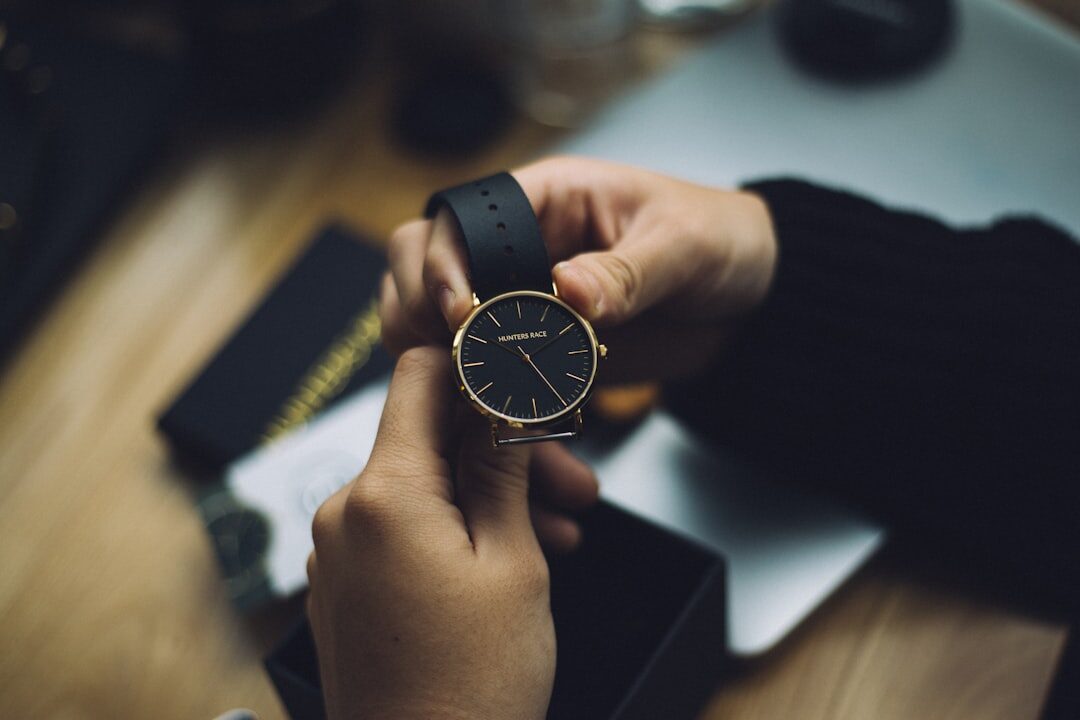 Elegant advisor presenting a watch box to a seated client in a private living room